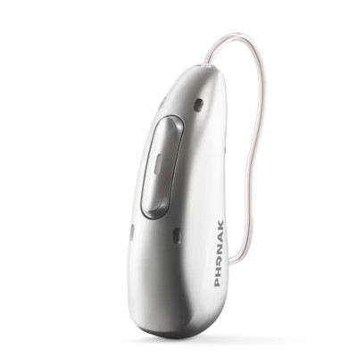 A close-up of a sleek, silver Phonak hearing aid with a thin, clear tube and a visible button, designed for behind-the-ear use.